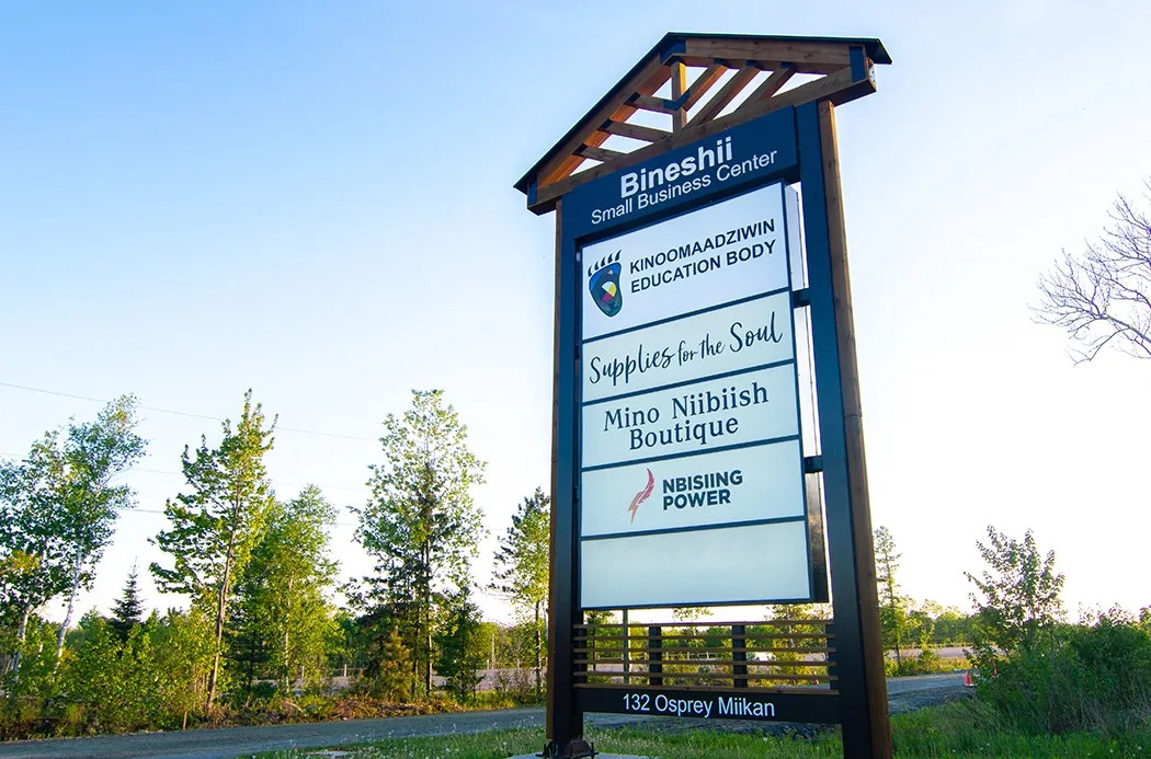 The Bineshii Small Business Centre sign at 132 Osprey Miikan, listing Nbisiing Power